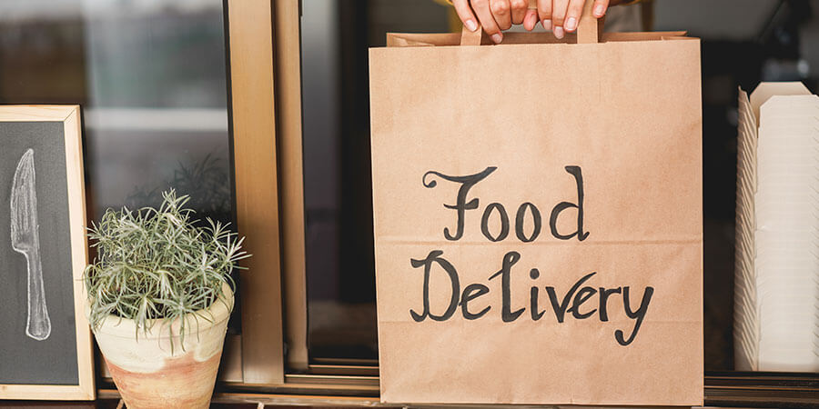 Young woman preparing food delivery inside ghost