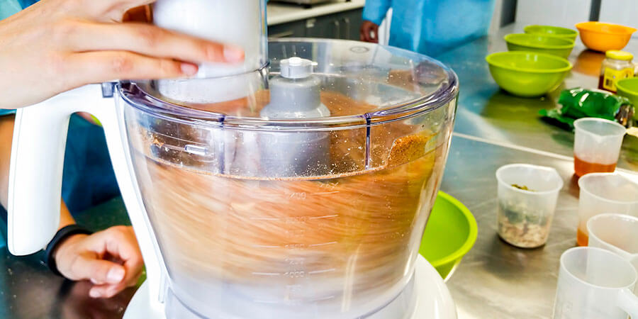 Electric food processor being used in a commercial kitchen