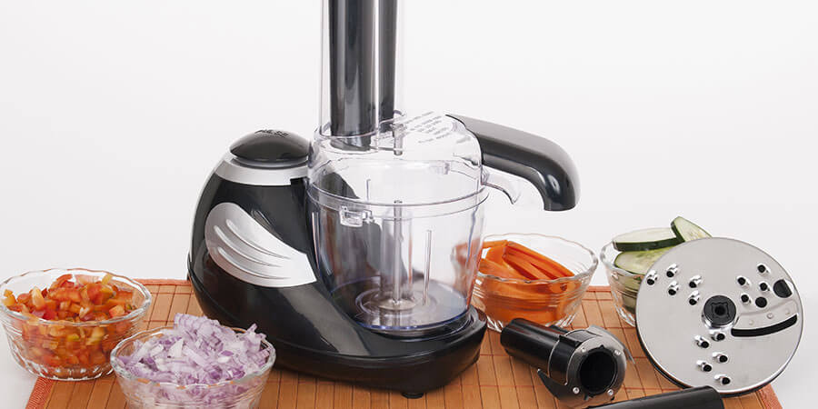 Food processor and attachments sit on kitchen counter