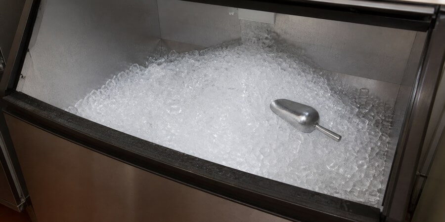 Open ice bin with ice mounded in the center and space around the sides